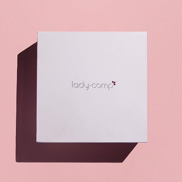 White box with 'lady-comp' branding on a pink background